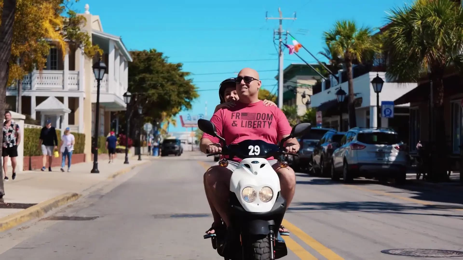 Couple cruising on a scooter through Key West