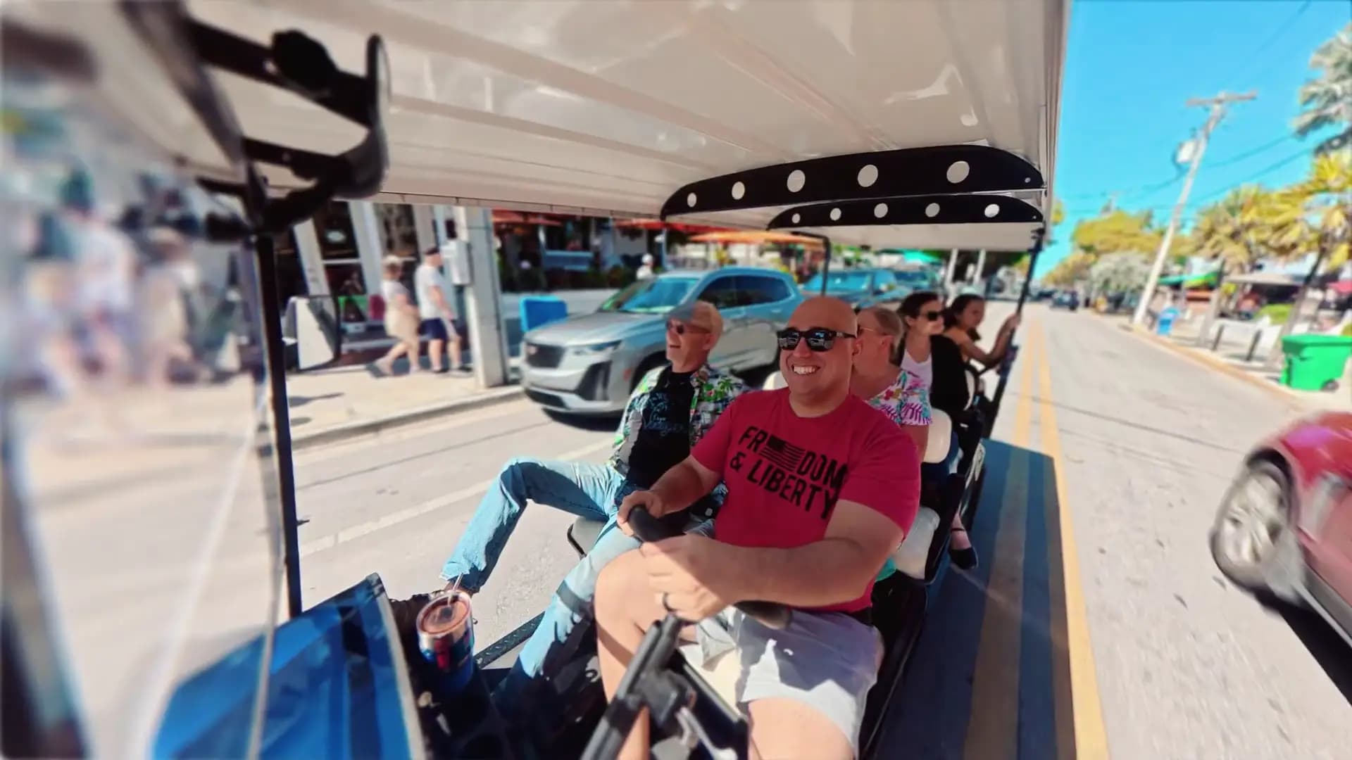 Group riding a golf cart down Duval Street